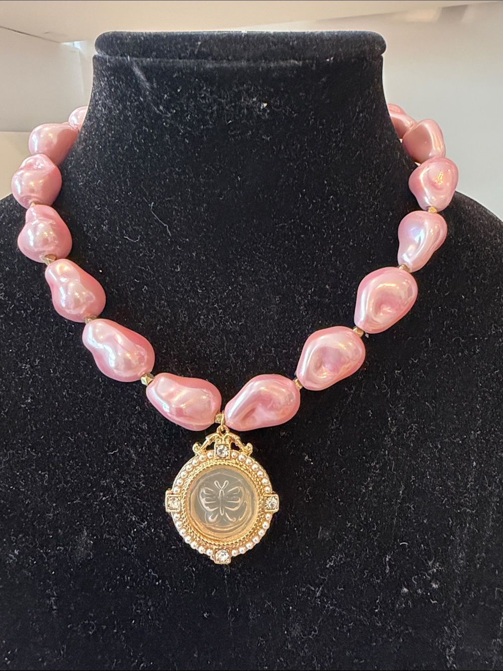 Pink Pearl Bead Necklace with Gold Pendant surrounded with pearls and stones.